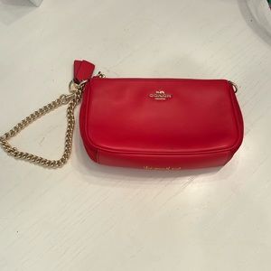 Red Selena Gomez X Coach Selena wristlet.